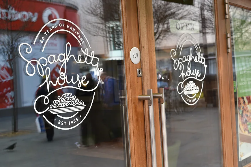 White Spaghetti House logo and lettering applied to glass entrance doors