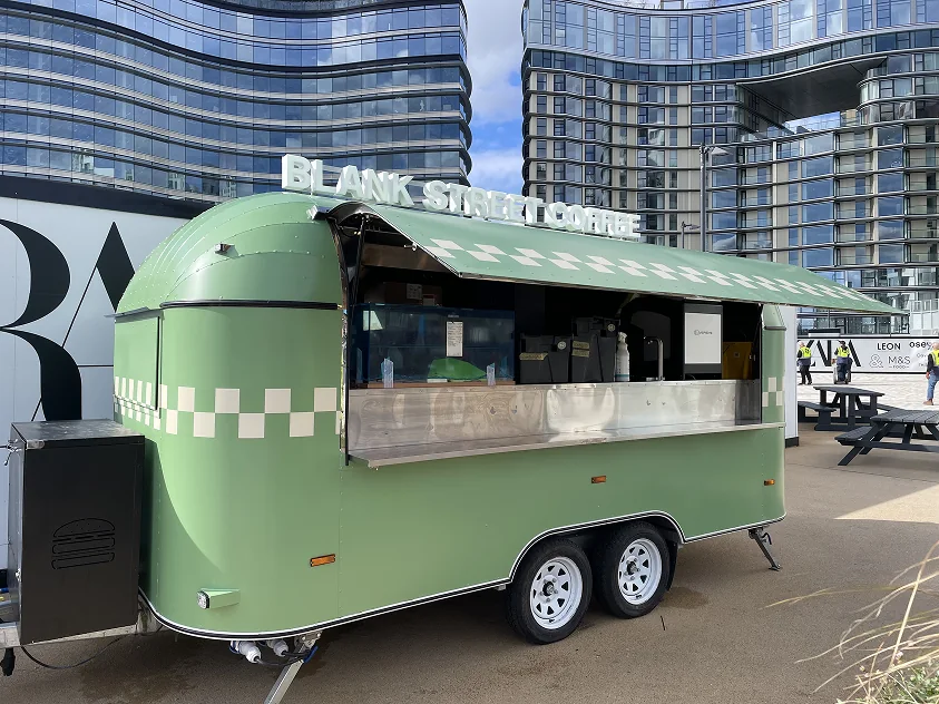 Green food trailer with contrasting applied graphics