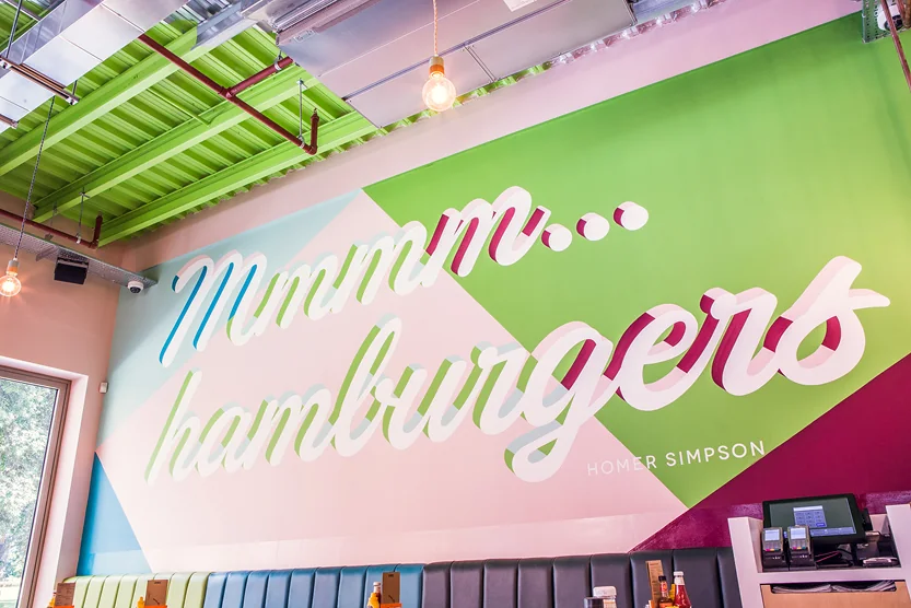 Colourful lettering mural above a counter