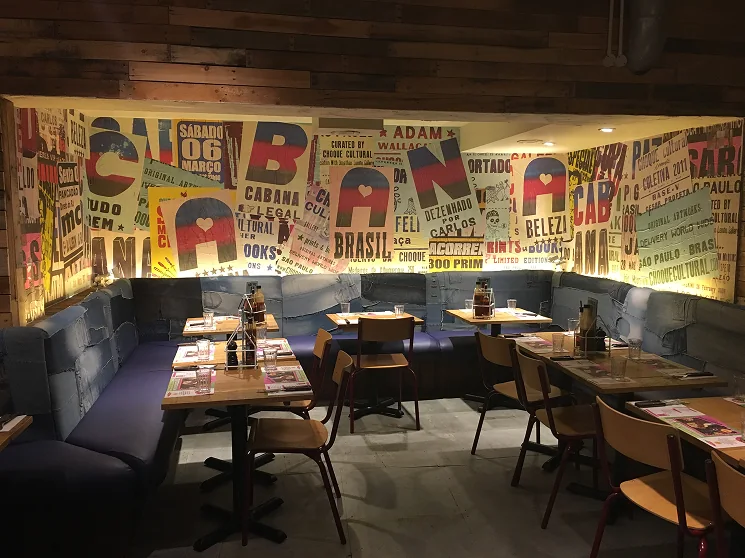 Printed typography mural across a restaurant wall