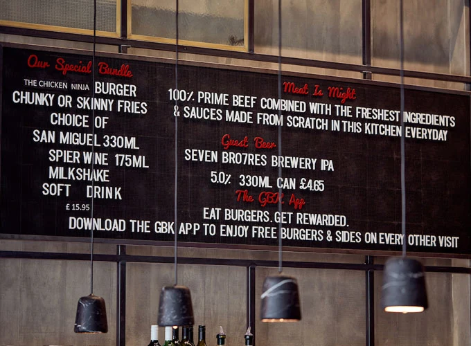 Chalk-style menu board displaying food and drink options
