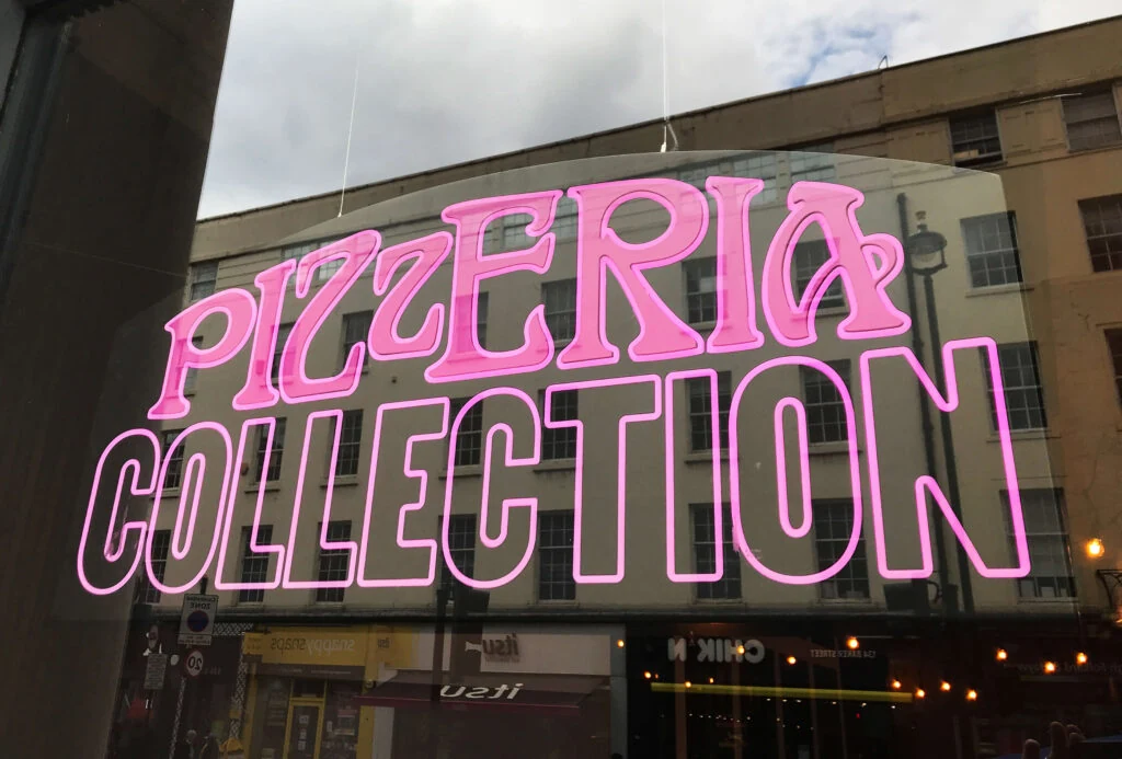 Pink Pizzeria Collection lettering above a storefront