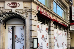 Exterior restaurant signage above a street entrance